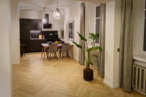 a kitchen and dining room with a table and chairs at Stylish apartment in the heart of Tallinn, free parking in Tallinn