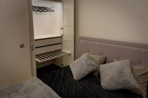 a bedroom with a bed with two pillows on it at Stylish apartment in the heart of Tallinn, free parking in Tallinn