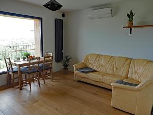 a living room with a couch and a table at Dębina z Widokiem in Poznań