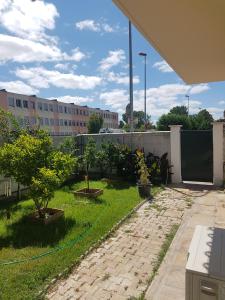 a garden with two trees and a fence at City Break in Narbonne