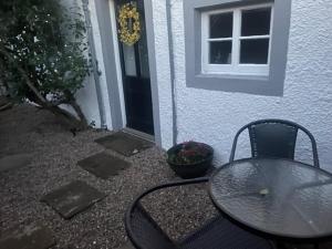 a table and chairs sitting in front of a house at White House in Carlisle