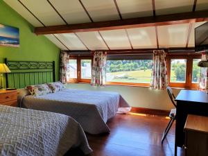 a bedroom with two beds and a window at Casa Bracamonte in Mondoñedo