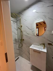 a white bathroom with a sink and a mirror at Vintage Apartment Rovinj Old Town in Rovinj