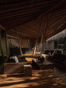 a living room with couches and a wooden ceiling at KA BRU Forest Villa in Itacaré