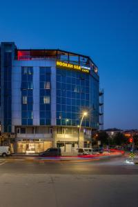 a large glass building with a sign on it at Grand Abimo Hotel in Istanbul