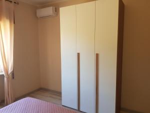 a white cabinet in a room with a bed at La Magnolia in San Giorgio a Liri