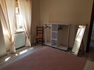 a room with a mirror and a chair and a window at La Magnolia in San Giorgio a Liri +8 photos