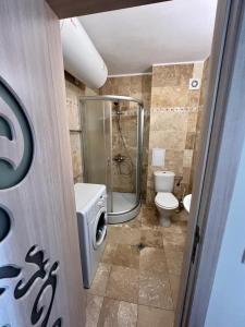 a bathroom with a toilet and a glass shower at apartment DIAMOND SARAFOVO in Burgas City