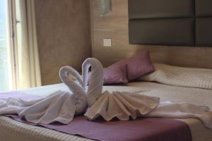 Postel nebo postele na pokoji v ubytování Hotel Miralago