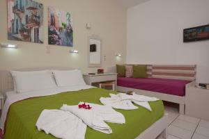 Postel nebo postele na pokoji v ubytování Latania Apartments