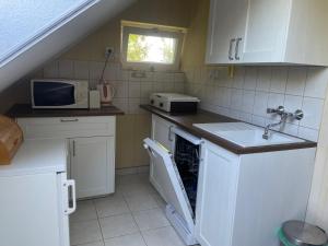 A kitchen or kitchenette at Piroska Apartment