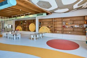 a room with tables and chairs and shelves at Stella Palace Aqua Park Resort in Hersonissos