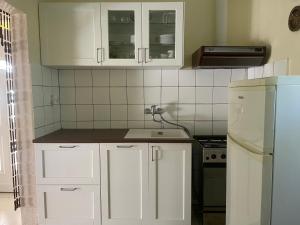 A kitchen or kitchenette at Piroska Apartment