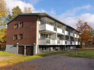 un gran edificio de ladrillo con un gran balcón en Lovely studio apartment, glazed balcony and own parking space, en Hyvinkää