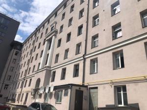 a large building with a car parked in front of it at Stylish apartment in the heart of Tallinn, free parking in Tallinn