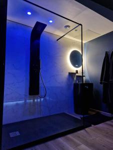a room with a blue room with a speaker and a mirror at La Love - Love room Marseille in Marseille