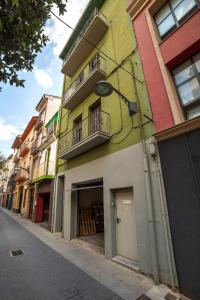a brightly colored building on the side of a street at Sant Ferriol in Olot