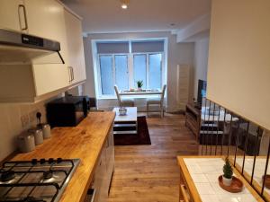 a kitchen and living room with a view of a table at Lovely 1-Bed Apartment in London in London