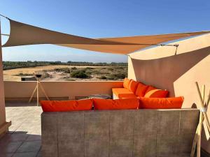 a couch under a canopy on a patio at Villa Alma, luxueuse villa au cœur de Marrakech in Marrakesh