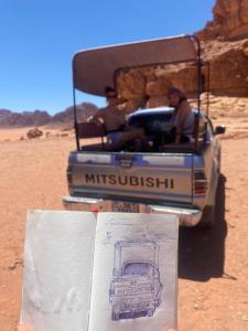 a drawing of a vehicle in the desert with two people at Desert Nights Camp in Wadi Rum