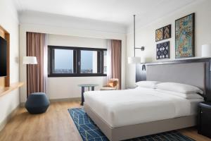 a hotel room with a bed and a tv at Casablanca Marriott Hotel in Casablanca