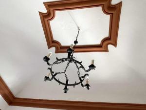 a chandelier in front of a mirror on a ceiling at Il Convento Ancient Apartment with private garden in Bellagio