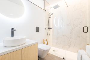 a bathroom with a shower and a toilet and a sink at LODO Suits Ria - Private Room by HD in Faro