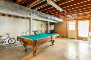 a room with a pool table in it at Home on the hill, nestled in the woods. in Farmington