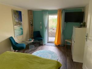 a bedroom with a bed and a television and a window at Schneewittchens Haus in Trebishain