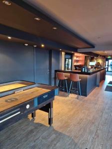 a pool table in a room with a bar at Ågotnes Hotell & Motell in Ågotnes