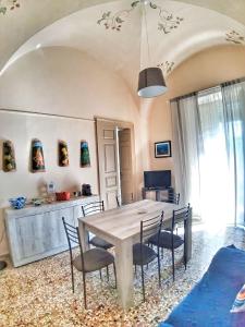 a dining room with a table and chairs at Casa Antonella in Acireale