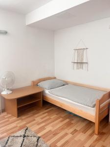 a bedroom with a bed and a table at Lovely basement rental in Bled