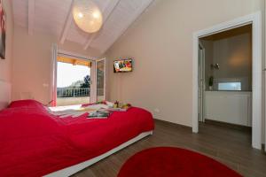 a bedroom with a red bed and a window at Villa Il Gelsomino Bellavista - Happy Rentals in Besozzo +29 photos