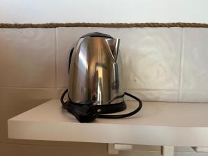 a tea kettle sitting on top of a shelf at La Maison de la Mer - 1er Étage in Fos-sur-Mer +7 photos