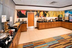a large room with a kitchen with a sink and counters at Fairfield Inn & Suites Weatherford in Weatherford