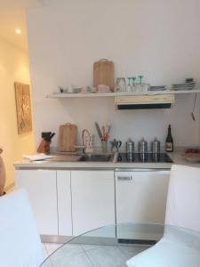 a kitchen with a sink and a counter top at Appartamento "Renata" in residence Cap Roux Eze Borde de Mer Costa Azzurra in Èze