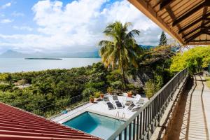 a balcony with a pool and a view of the water at Le Morne Vista in Le Morne