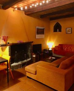 a living room with a couch and a fireplace at Casa Odette Calcata in Calcata