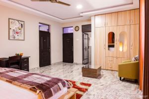 a bedroom with a bed and a desk and a chair at Richjoy Lodge in Tema