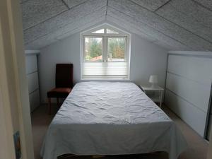 a bedroom with a large bed and a window at Silkeborg Legoland luxury cabin in Silkeborg