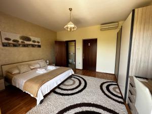 a bedroom with a bed and a tv and a rug at Apartments & Rooms Marina in Dramalj