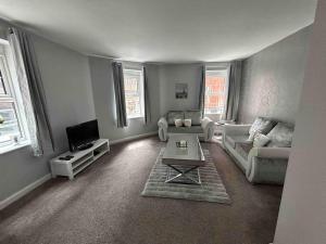 a living room with a couch and a table at Apartment In Birmingham City Centre in Birmingham