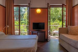 Postel nebo postele na pokoji v ubytování Hotel Villa Mabapa + 37 fotografií