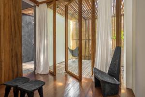a living room with two chairs and a mirror at KA BRU Beach Boutique Hotel in Barra Grande