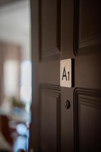 a door with aat sign on it in a room at OTIUM living in Volos +60 photos
