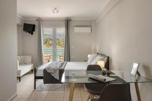 a hotel room with a bed and a glass table at Fidias city rooms in Argostoli