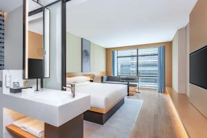 a hotel room with a bed and a sink at Fairfield by Marriott Beijing Daxing Airport in Beijing