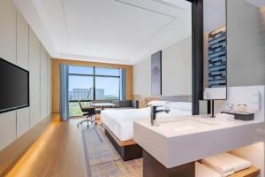 a hotel room with a large bed and a sink at Fairfield by Marriott Beijing Daxing Airport in Beijing