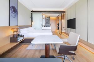 a room with a bed and a table and chairs at Fairfield by Marriott Beijing Daxing Airport in Beijing