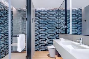 a bathroom with a sink and a toilet and a mirror at Fairfield by Marriott Beijing Daxing Airport in Beijing
